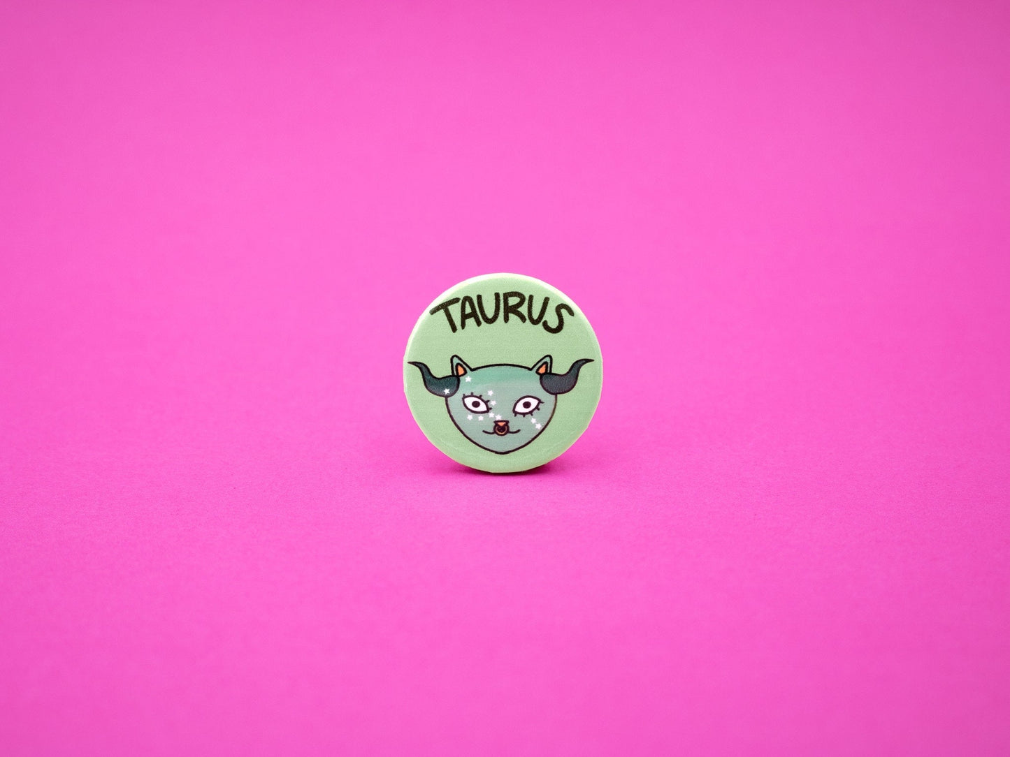 taurus cat badge in green with the text 'taurus'