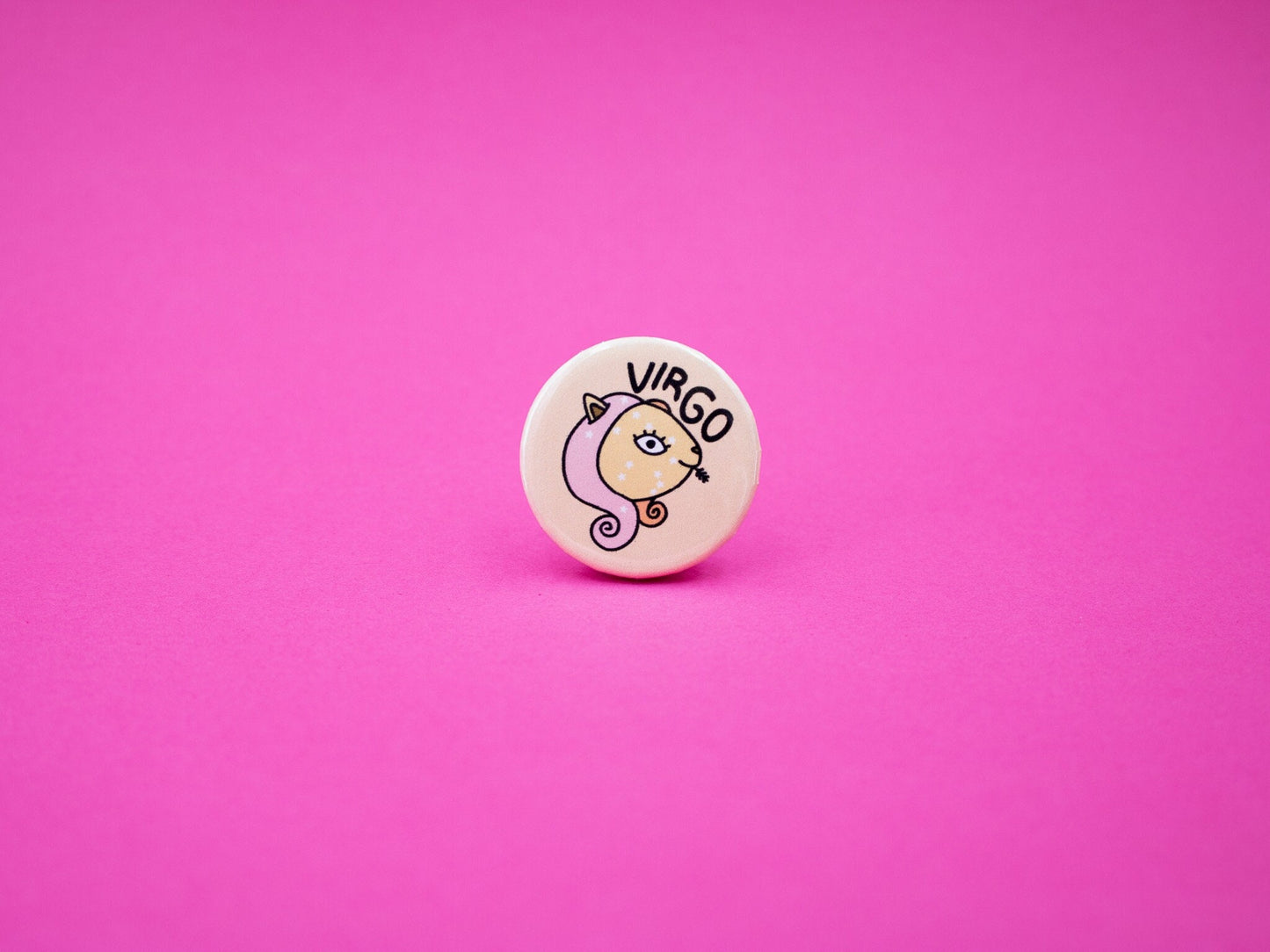 virgo cat badge in yellow and pink colours featuring cat with wheat poking out her mouth and the word 'VIRGO'