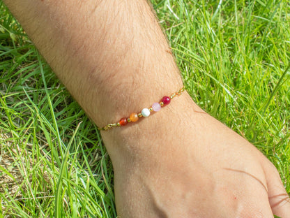 gold bracelet with semi precious gemstone beads in the colours of the lesbian pride flag