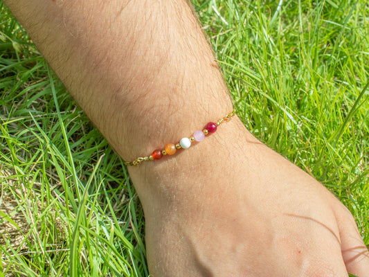 gold bracelet with semi precious gemstone beads in the colours of the lesbian pride flag