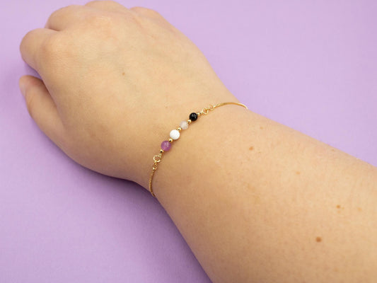 gold bracelet with gemstone beads in the colours of the asexual flag