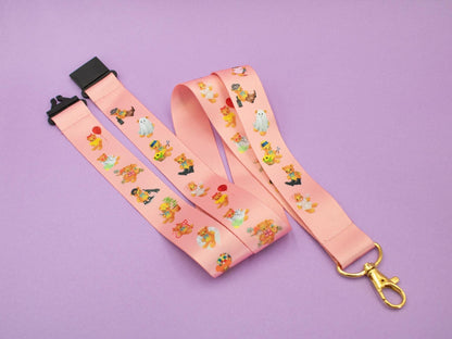 pink colour lanyard with teddy bear print with gold hook and black plastic breakaway